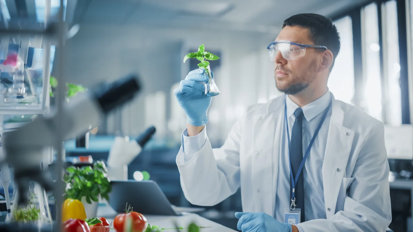 Researcher in a white coat reviewing botanical actives used in Eros Lift